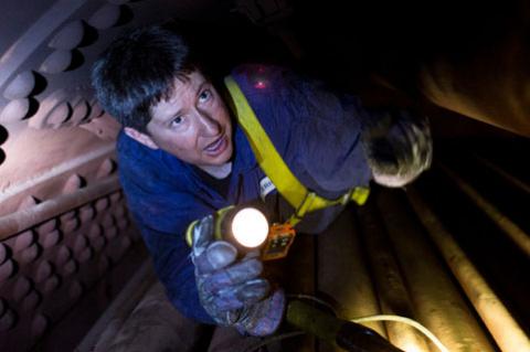 Eric Hadder inspects a boiler