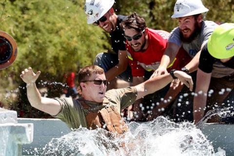 UA rock-drilling winners take a dunking in Old Main fountain.