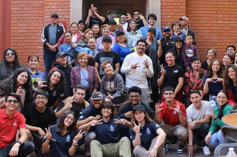 Students and event participants pose for a photo in the Old Engineering Building courtyard.