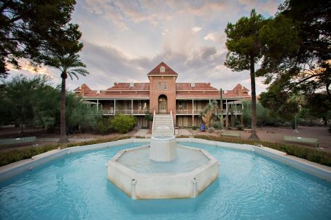 A shot of the University of Arizona's Old Main building, with a fountain in the foreground.