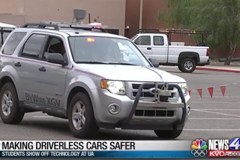 Screencap of a newscast with a car driving across the frame and a lower-third caption that reads, "Making Driverless Cars Safer: Students Show Off Technology at UA"