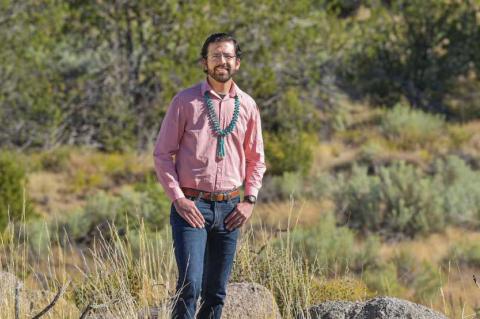 Dylan Moriarty, outdoors, thumbs in his jean pockets.