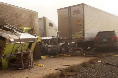 A multicar accident on a dusty roadside