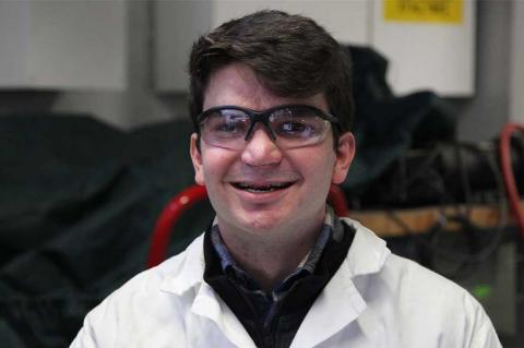 Gabriel Schirn wearing protective eye gear and a lab coat