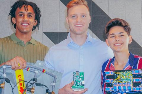 three people pose with computer parts