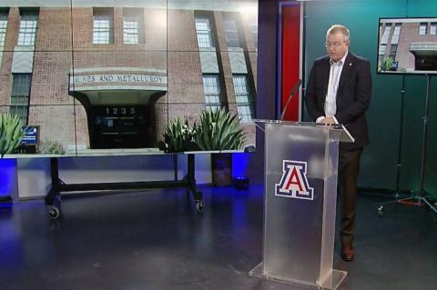 Screenshot of a video in which David W. Hahn stands at a podium speaking, with an image of the Old Engineering building behind him.