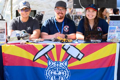 Students sit at an expo table