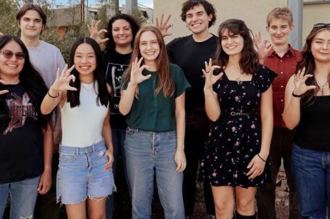 nine students pose outdoors