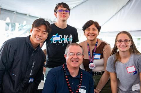 Dean David Hahn poses for a photo with four incoming engineering students