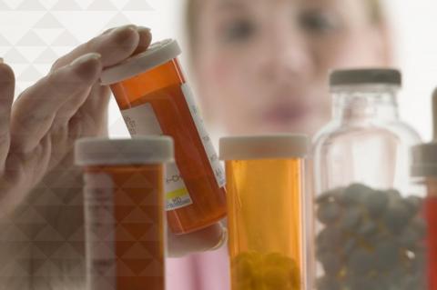 a pharmacist examines medications