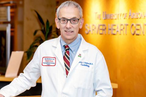 Marvin J. Slepian stands in front of a Sarver Heart Center sign wearing a lab coat