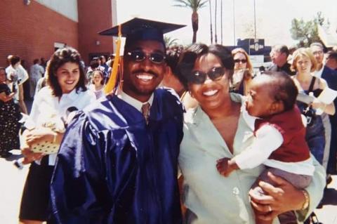 Brian Mushimba with his wife & son at his UA graduation.