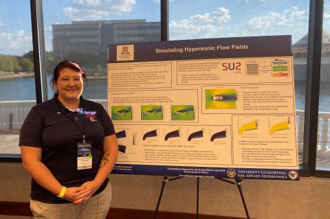Avery Stockdale-Stepehens stands with a poster pesentation called "Simulating Hypersonic Flow Fields"
