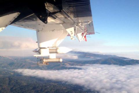 Photo taken from inside an airplane flying above the cloud layer.