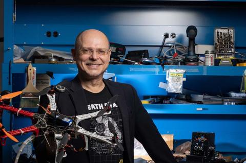Wolfgang Fink poses with a planetary rover