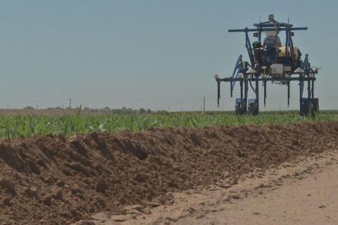 A high-tech tractor-type vehicle moves across a field.