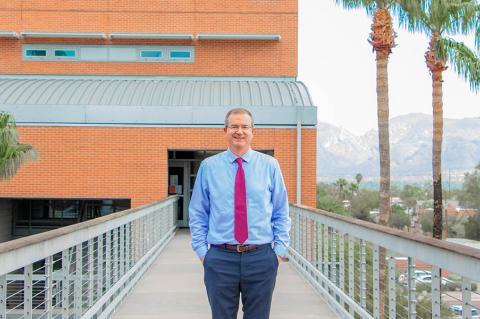 David Hahn stands on the exterior footbridge between the two sections of the Aerospace & Mechanical Engineering Building.