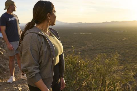 Two students gaze at the desert landscape