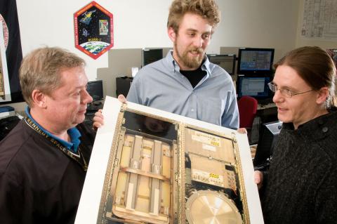 engineers examine test equipment