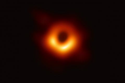 Photo of a black hole -- it looks like an orange ring surrounded by blackness