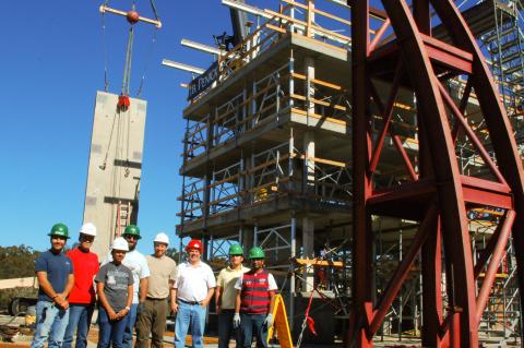 engineers standing next to giant earthquake test rig