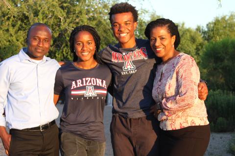 A family of four poses outdoors