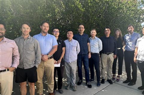 a large group of instructors poses outdoors