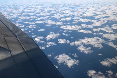 a view of clouds and an airplane wing