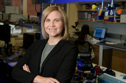 Jennifer Barton, professionally posed and smiling in a biomedical lab.