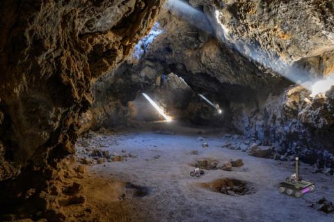 artist's impression of the breadcrumb scenario, autonomous rovers can be seen exploring a lava tube after being deployed by a mother rover that remains at the entrance to maintain contact with an orbiter or a blimp