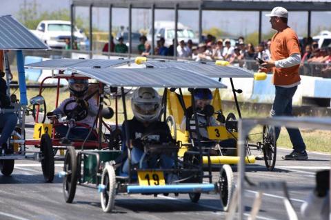 Students in solar-powered go-karts get ready at the starting line of a race.