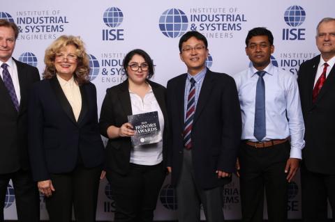 Six professionals pose for a photo in front of an IISE backdrop.