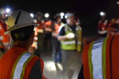 a group of students tour a dark mine