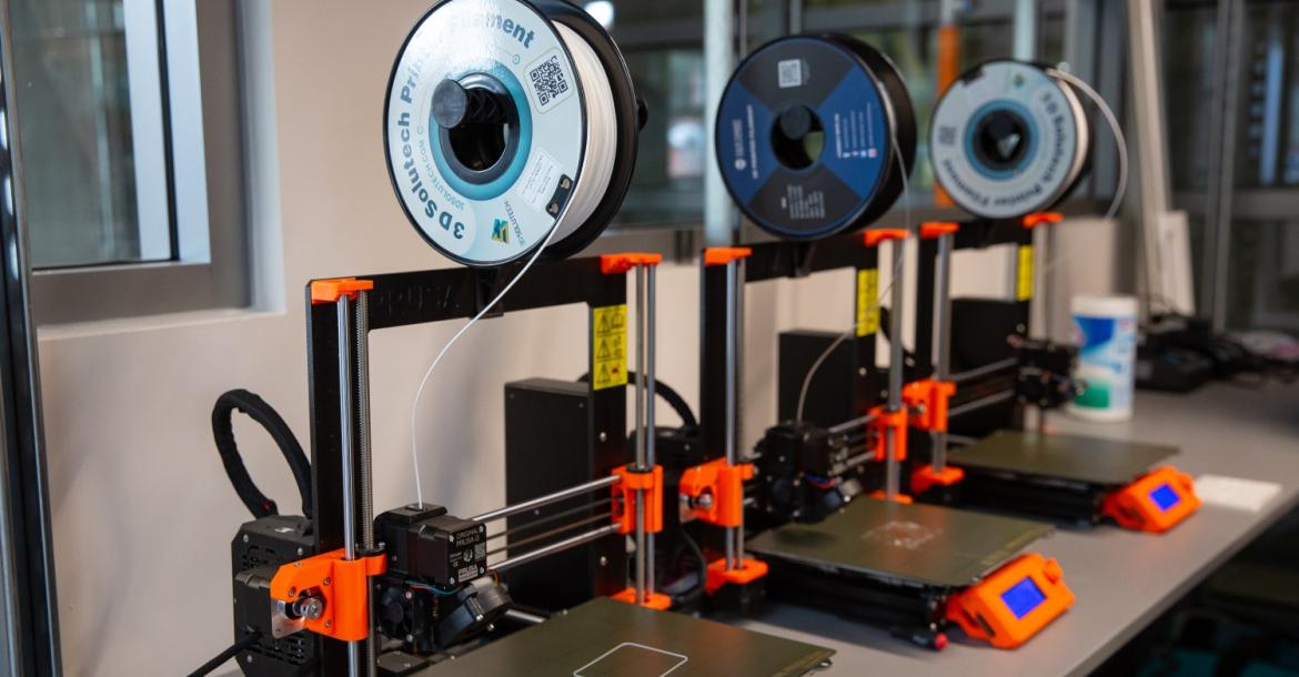 three 3D printers in a lab