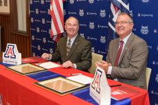 Edward Ayer and David Hahn sign the Education Partnership Agreement.