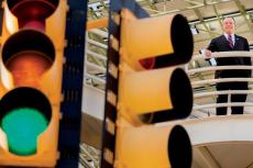 Larry Head stands behind traffic lights