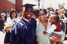 Brian Mushimba with his wife & son at his UA graduation.