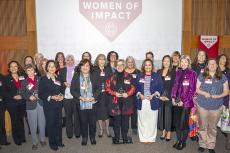 all awardees pose under a banner