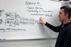 Gregory Ditzler explains a concept at a whiteboard.