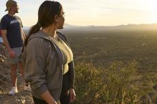 Two students gaze at the desert landscape