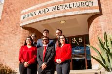 Five students stand on the front steps of the Mines and Metallurgy building.